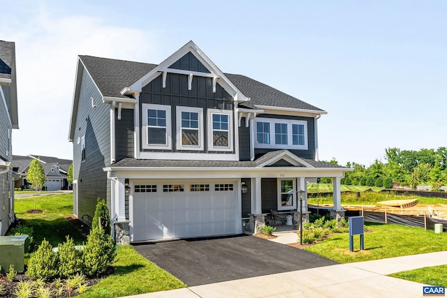 13A Sablewood Dr, Charlottesville, VA 22911 - view of front of house with aphalt driveway, a garage, a front yard, board and batten siding, and a porch