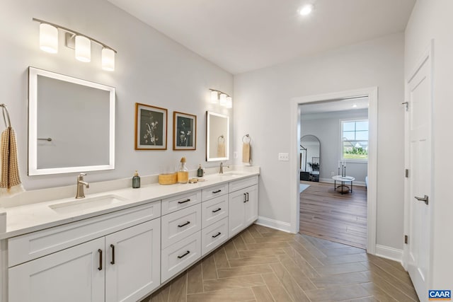 13A Sablewood Dr, Charlottesville, VA 22911 - bathroom featuring double vanity, a sink, parquet floors, and baseboards
