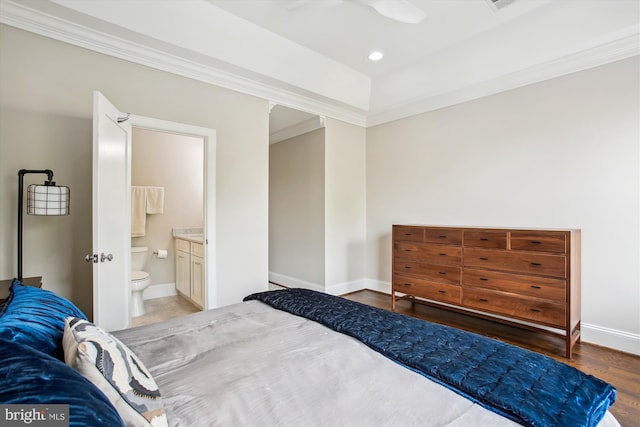 bedroom featuring recessed lighting, ensuite bath, crown molding, baseboards, and wood finished floors