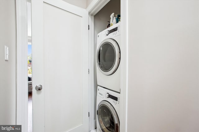 laundry area with stacked washer / dryer and laundry area