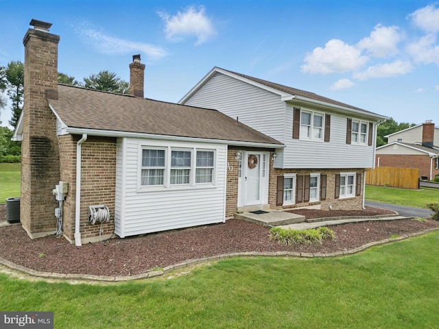 30 Stardust Dr, Newark, DE 19702 - tri-level home featuring brick siding, a chimney, and roof with shingles
