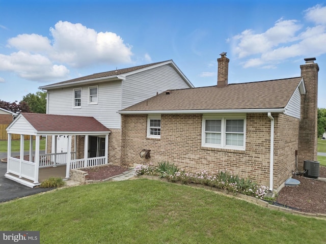 30 Stardust Dr, Newark, DE 19702 - back of house with a chimney, brick siding, a yard, and a porch