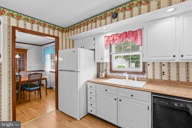 30 Stardust Dr, Newark, DE 19702 - kitchen featuring wallpapered walls, freestanding refrigerator, dishwasher, a sink, and white cabinets