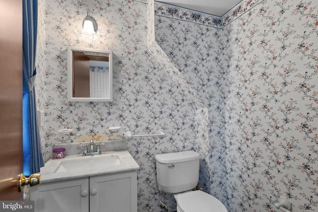 30 Stardust Dr, Newark, DE 19702 - bathroom with toilet, vanity, and wallpapered walls