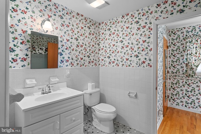 30 Stardust Dr, Newark, DE 19702 - full bathroom featuring wallpapered walls, a wainscoted wall, tile walls, vanity, and toilet
