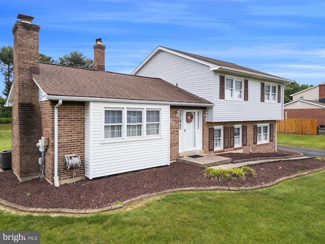 30 Stardust Dr, Newark, DE 19702 - split level home featuring brick siding, a chimney, cooling unit, and a shingled roof