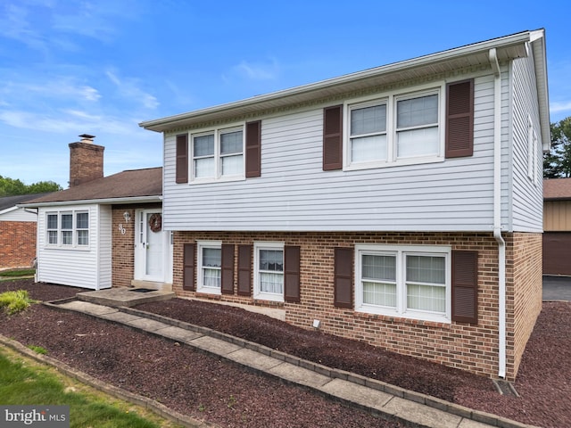 30 Stardust Dr, Newark, DE 19702 - split level home with brick siding and a chimney