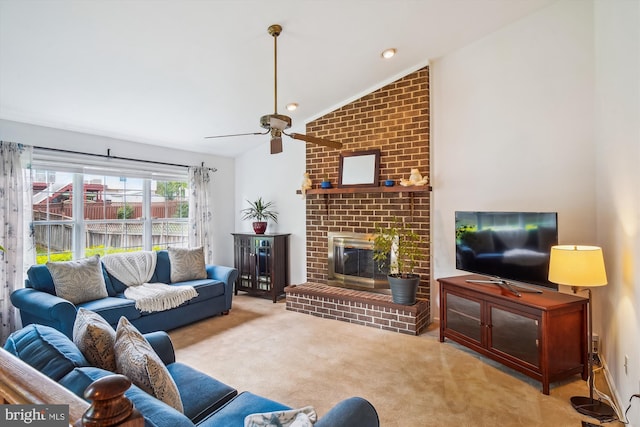 living area with a brick fireplace, ceiling fan, lofted ceiling, and carpet