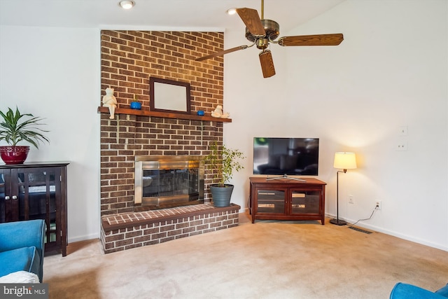 carpeted living room with a brick fireplace, a ceiling fan, baseboards, and visible vents