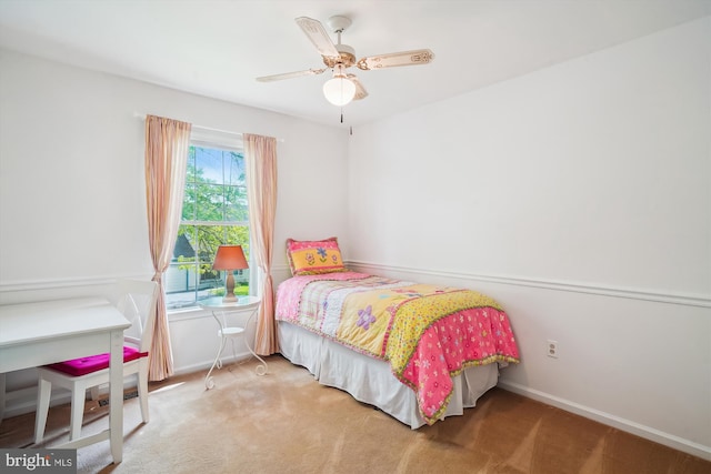 carpeted bedroom featuring baseboards and a ceiling fan