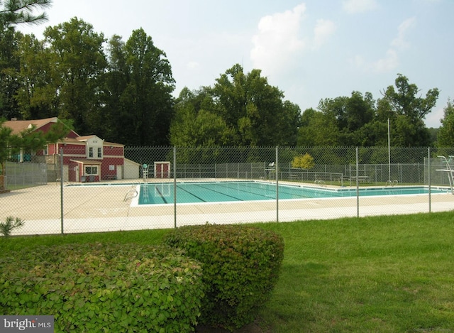 pool with fence and a yard