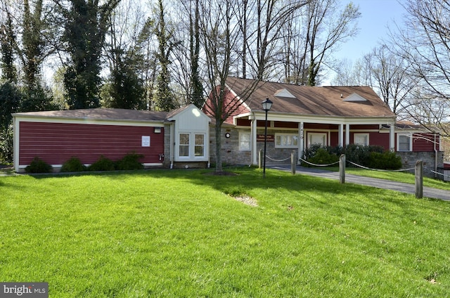cape cod house with a front lawn and stone siding