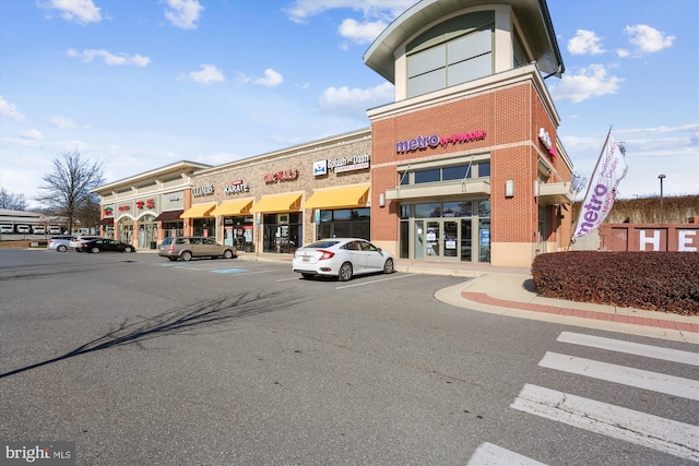 view of building exterior with uncovered parking