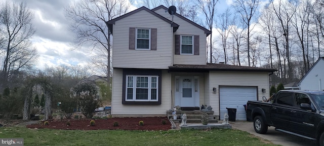 view of front of home with a garage, driveway, and a front lawn