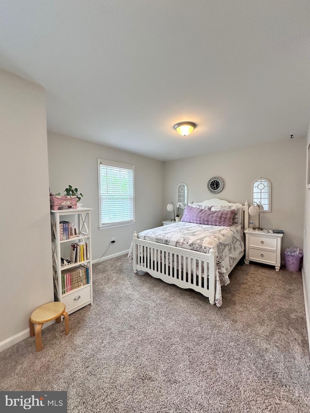 carpeted bedroom featuring baseboards