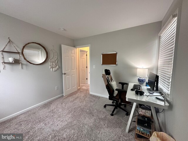 carpeted home office with baseboards