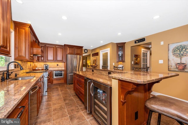 8412 Dasher Ct, Gaithersburg, MD 20882 - kitchen featuring wine cooler, stainless steel appliances, a sink, a kitchen breakfast bar, and decorative backsplash