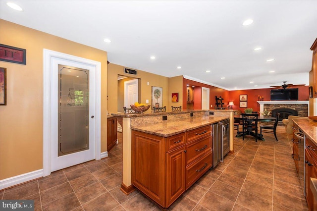 8412 Dasher Ct, Gaithersburg, MD 20882 - kitchen with brown cabinetry, recessed lighting, light stone countertops, open floor plan, and wine cooler