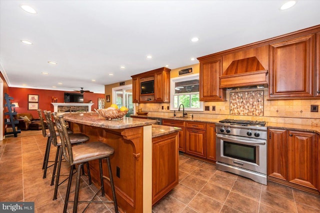 8412 Dasher Ct, Gaithersburg, MD 20882 - kitchen with stainless steel range, custom exhaust hood, a sink, a kitchen breakfast bar, and recessed lighting