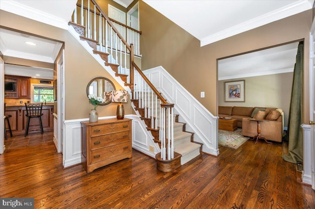 8412 Dasher Ct, Gaithersburg, MD 20882 - staircase featuring crown molding, wood finished floors, wainscoting, and a decorative wall