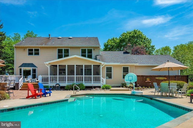 8412 Dasher Ct, Gaithersburg, MD 20882 - back of property with a sunroom, a patio, a chimney, a wooden deck, and outdoor dining area