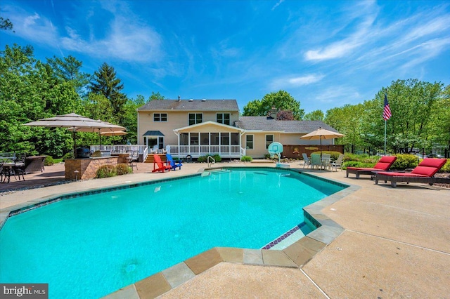 8412 Dasher Ct, Gaithersburg, MD 20882 - view of swimming pool with a patio area, a sunroom, outdoor dining space, and fence