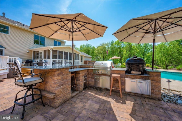 8412 Dasher Ct, Gaithersburg, MD 20882 - view of patio / terrace with an outdoor kitchen, a sunroom, a bar, and area for grilling