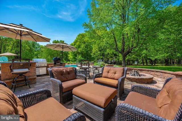 8412 Dasher Ct, Gaithersburg, MD 20882 - view of patio / terrace featuring grilling area, an outdoor living space with a fire pit, exterior kitchen, and view of wooded area