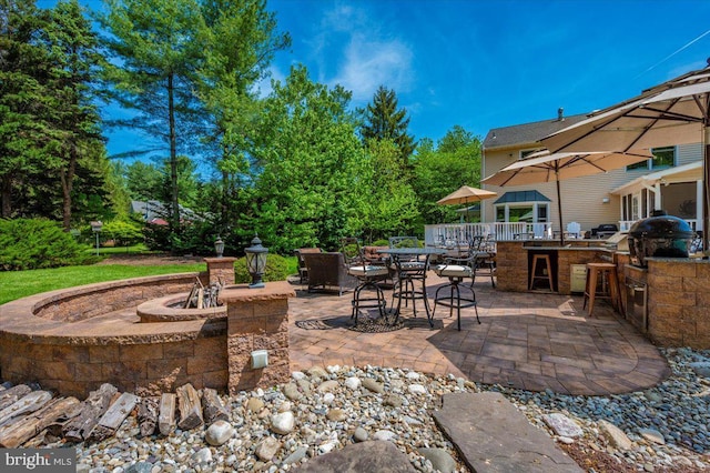 8412 Dasher Ct, Gaithersburg, MD 20882 - view of patio featuring an outdoor kitchen, an outdoor fire pit, outdoor dining area, area for grilling, and view of scattered trees
