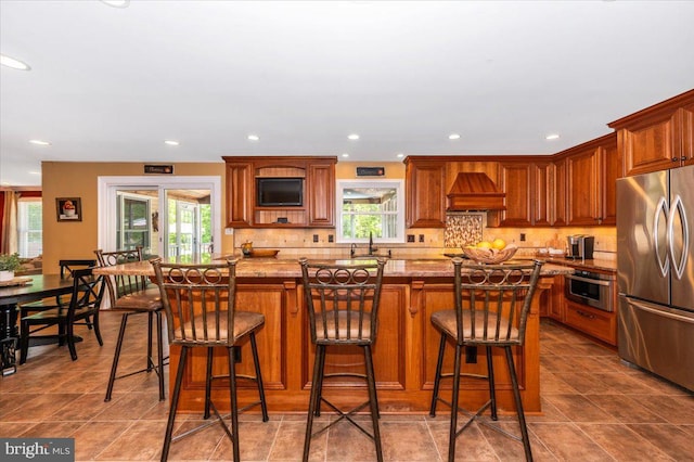 8412 Dasher Ct, Gaithersburg, MD 20882 - kitchen featuring stainless steel appliances, custom range hood, healthy amount of natural light, backsplash, and recessed lighting