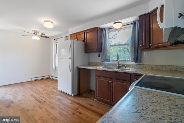 1722 Antler Ln, Finksburg, MD 21048 - kitchen featuring white appliances, a sink, light wood finished floors, a baseboard radiator, and a ceiling fan