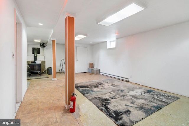 1722 Antler Ln, Finksburg, MD 21048 - below grade area with a baseboard radiator, a wood stove, and recessed lighting