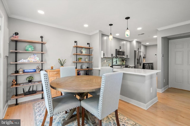 43426 Edgecliff Ter, Ashburn, VA 20147 - dining space with light wood-style floors, baseboards, and crown molding