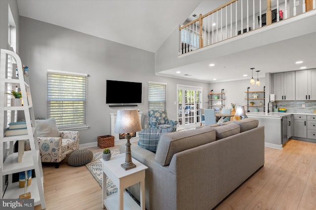 43426 Edgecliff Ter, Ashburn, VA 20147 - living area with baseboards, recessed lighting, light wood-style flooring, and high vaulted ceiling