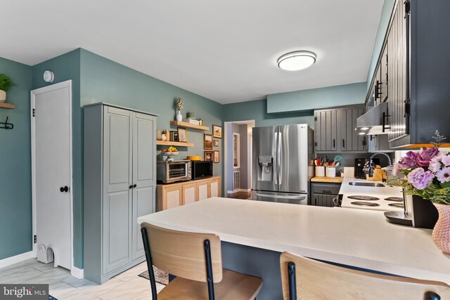 3 Round Hill Rd, Camp Hill, PA 17011 - kitchen with a peninsula, stainless steel refrigerator with ice dispenser, marble finish floor, a sink, and extractor fan