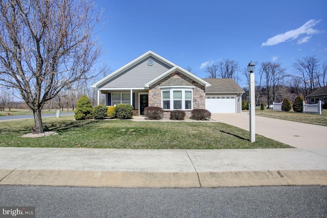 102 Colonial Ct, Shippensburg, PA 17257 - view of front of house with a front yard, stone siding, a garage, and concrete driveway