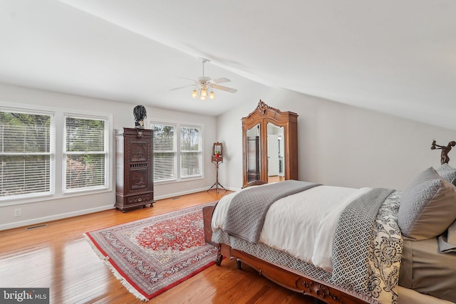 8519 Century Oak Ct, Fairfax Station, VA 22039 - bedroom featuring ceiling fan, visible vents, vaulted ceiling, wood finished floors, and baseboards