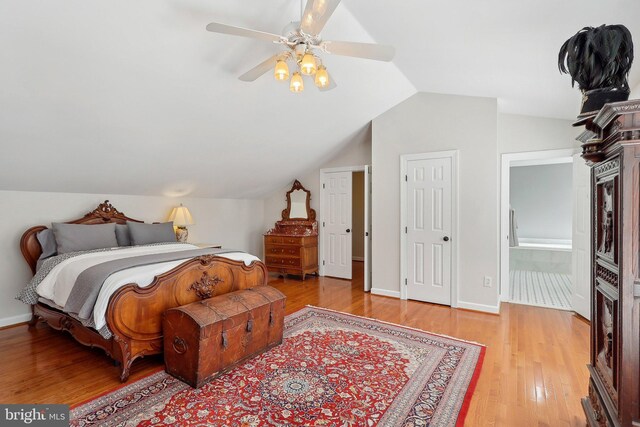 8519 Century Oak Ct, Fairfax Station, VA 22039 - bedroom featuring baseboards, connected bathroom, wood finished floors, and lofted ceiling