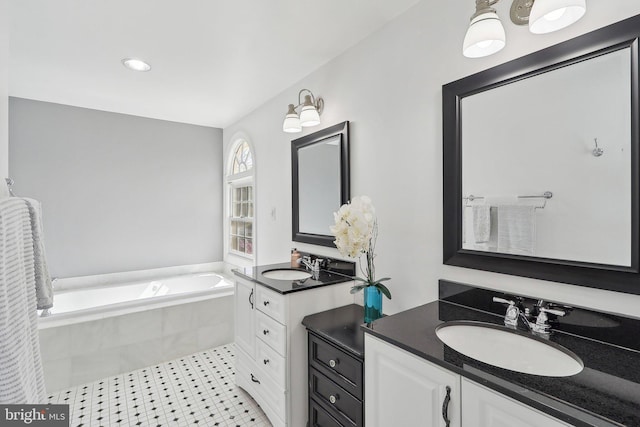 8519 Century Oak Ct, Fairfax Station, VA 22039 - full bath with tile patterned floors, a garden tub, two vanities, and a sink