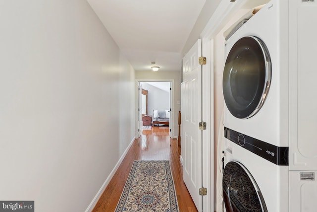 8519 Century Oak Ct, Fairfax Station, VA 22039 - washroom with baseboards, laundry area, wood finished floors, and stacked washer and clothes dryer