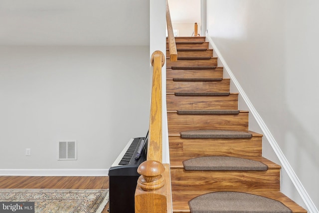 8519 Century Oak Ct, Fairfax Station, VA 22039 - stairs with wood finished floors, baseboards, and visible vents
