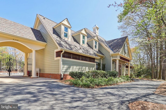 8519 Century Oak Ct, Fairfax Station, VA 22039 - view of side of property with roof with shingles, aphalt driveway, and a gate