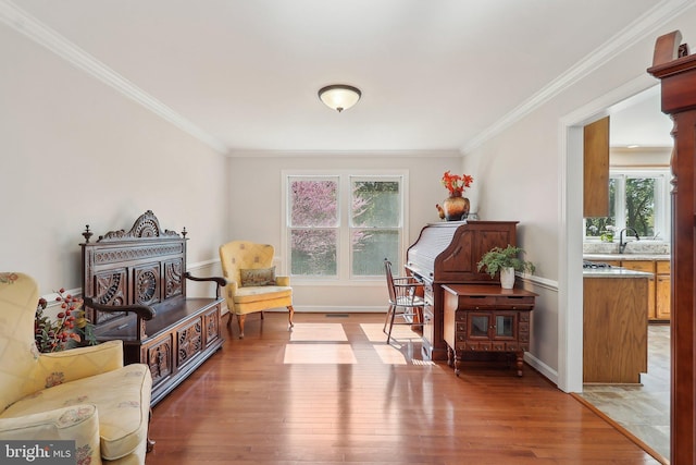 8519 Century Oak Ct, Fairfax Station, VA 22039 - sitting room featuring baseboards, light wood-type flooring, ornamental molding, and a healthy amount of sunlight