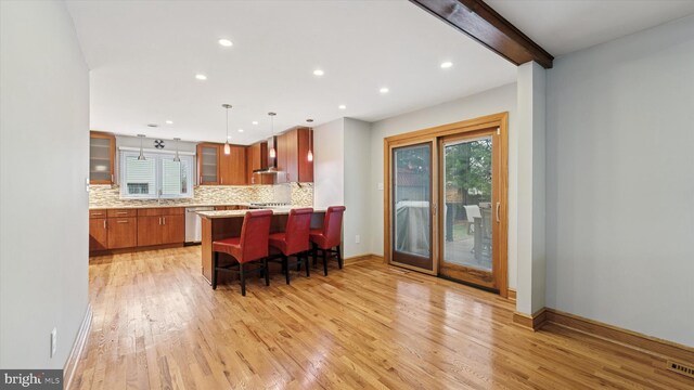 115 Union Mill Ter, Mount Laurel, NJ 08054 - kitchen featuring glass insert cabinets, a kitchen breakfast bar, dishwasher, light wood finished floors, and decorative backsplash