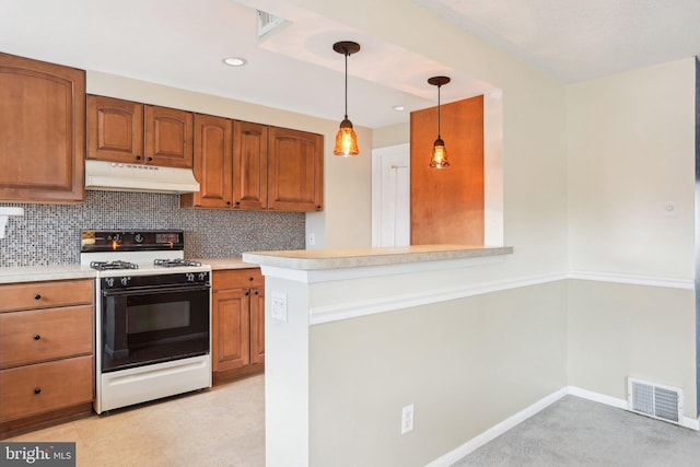 kitchen with visible vents, range with gas stovetop, brown cabinets, tasteful backsplash, and under cabinet range hood