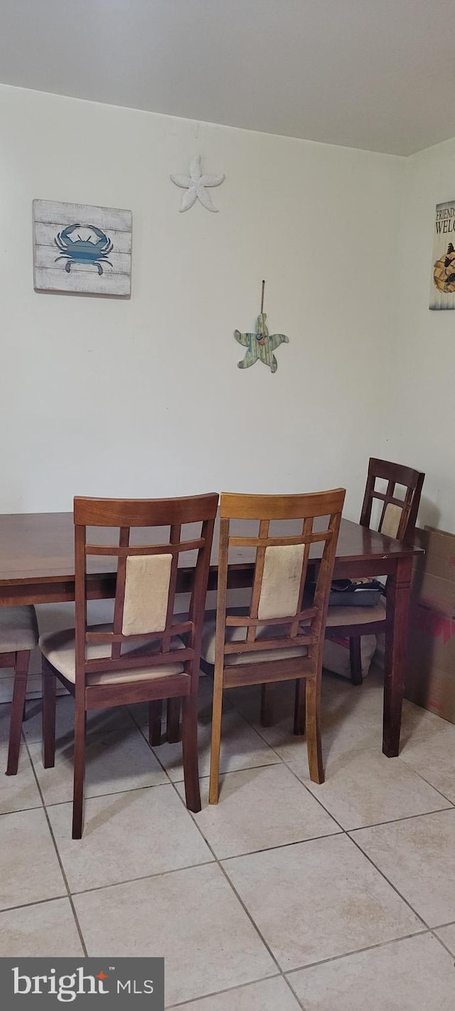 dining space with light tile patterned floors