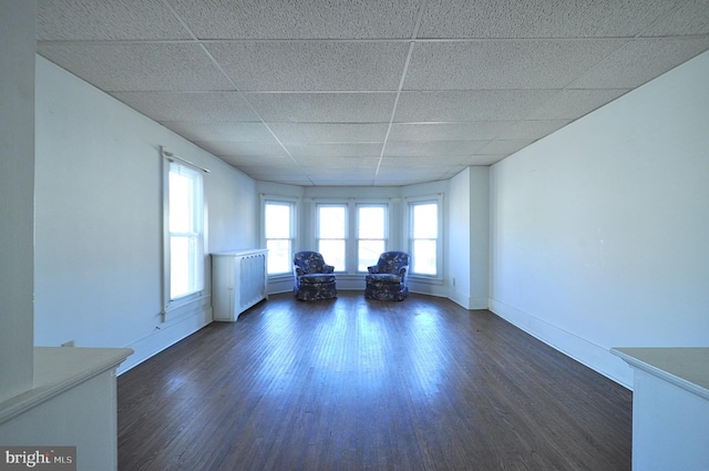 109 N Centre St, Philipsburg, PA 16866 - unfurnished living room featuring dark wood-type flooring, baseboards, and a drop ceiling