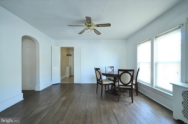 109 N Centre St, Philipsburg, PA 16866 - dining room with arched walkways, baseboards, a ceiling fan, and dark wood finished floors