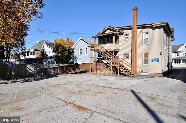 109 N Centre St, Philipsburg, PA 16866 - back of property featuring stairway, fence, and a chimney