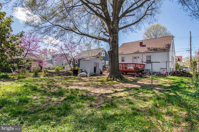view of yard featuring a deck and fence